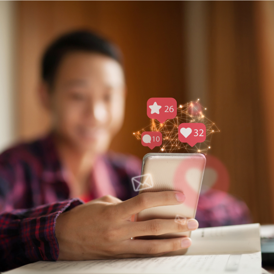 mobile phone with social media icons bursting from screen