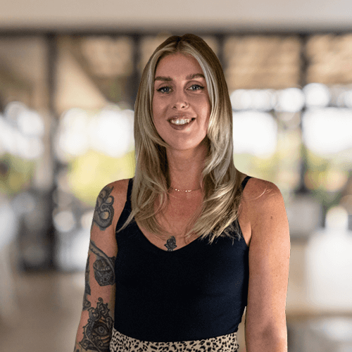 Headshot of SEO Manager Hollie smiling against blurred office background