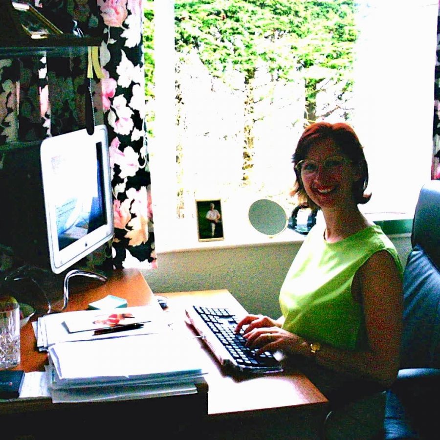 Woman smiling while working at desk in home office