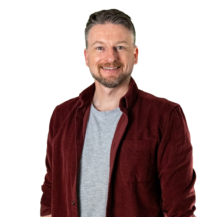 James Alderman smiling at the camera