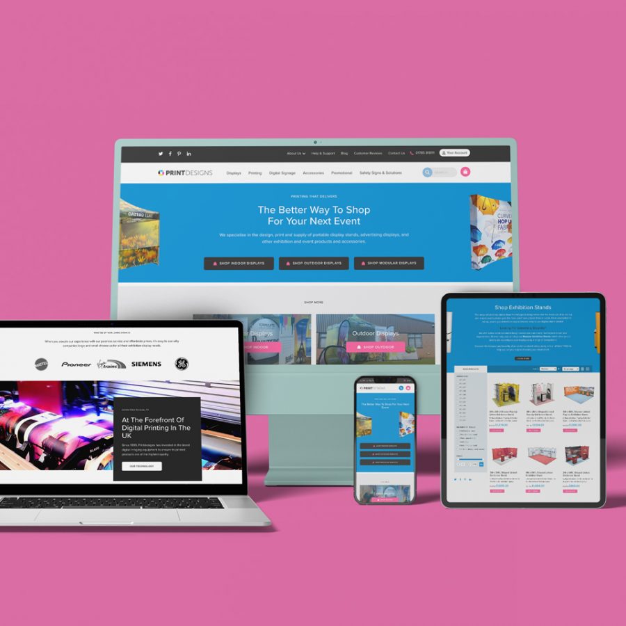 A variety of devices, including desktop monitor, laptop, mobile and tablet against a pink background. All displaying various webpages from the Print Designs website.