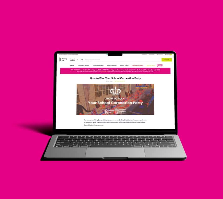 Laptop displaying Running Imp website, against pink background