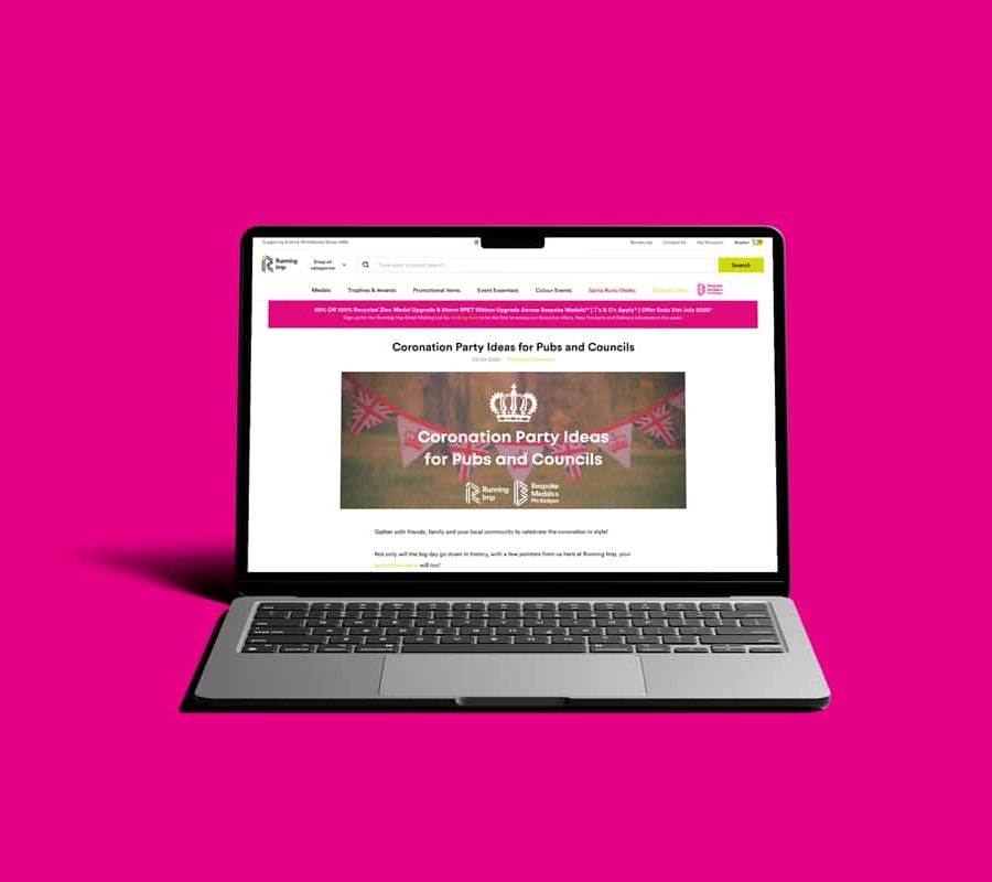 Laptop displaying Running Imp website, against pink background